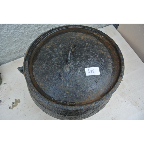 518 - A large cast iron cooking pot with original lid.