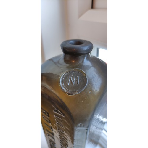 197a - An 1860's sealed & embossed Gin bottle. 10.75ins tall. Mid green, square body tapers out, pig snout ... 