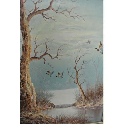 100 - A vintage framed painting of a forest scene with ducks, signed by J.Deanes.