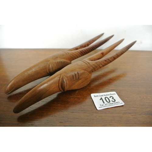 103 - A vintage pair of beautifully craved wooden models of African antelope heads.