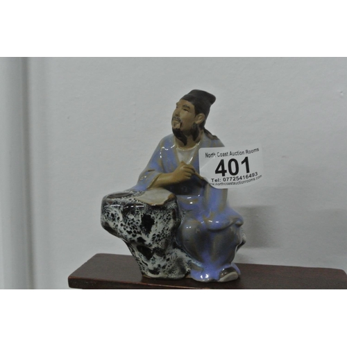 401 - A ceramic Chinese/ Oriental figure.