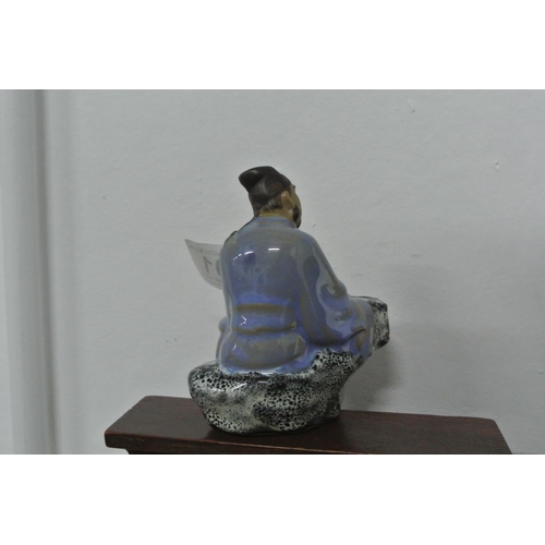 401 - A ceramic Chinese/ Oriental figure.