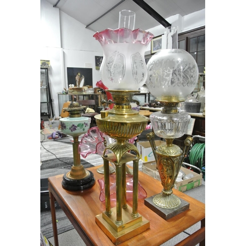 424 - A stunning antique 4 column brass oil lamp with decorative etched ruby glass shade.