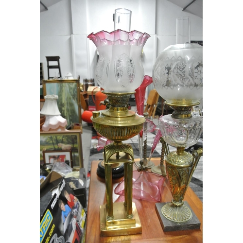 424 - A stunning antique 4 column brass oil lamp with decorative etched ruby glass shade.