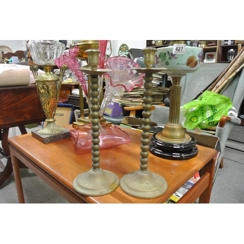 433 - A pair of antique brass candlesticks.