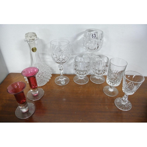 83 - A collection of crystal glasses along with a French decanter.