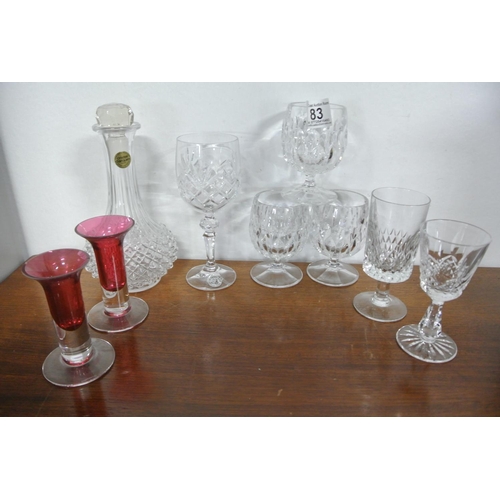 83 - A collection of crystal glasses along with a French decanter.