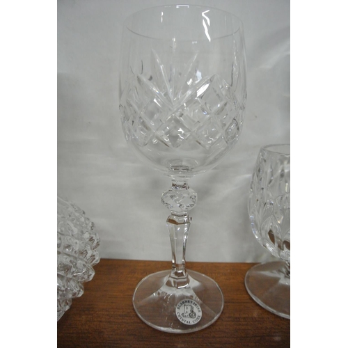 83 - A collection of crystal glasses along with a French decanter.