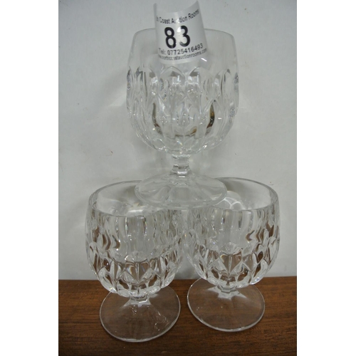 83 - A collection of crystal glasses along with a French decanter.