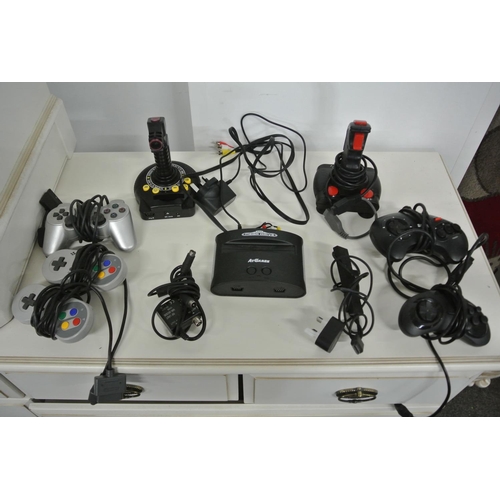 147 - A retro Sega Mega Drive along with assortment of retro controllers to include joy sticks, super Nint... 