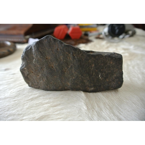 197 - A 4000 BC unpolished black stone axe head.