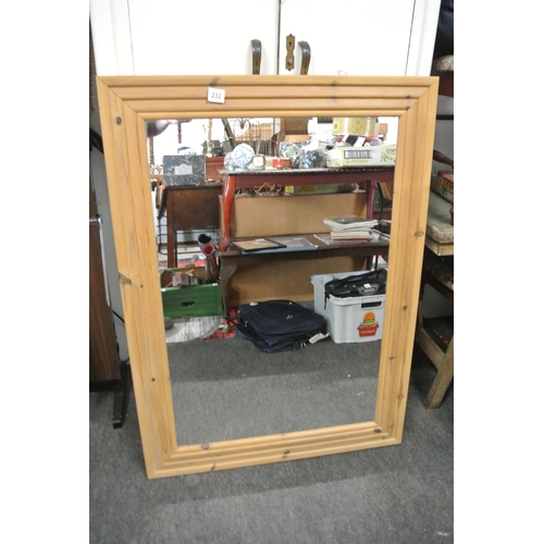 232 - A large pine framed mirror.