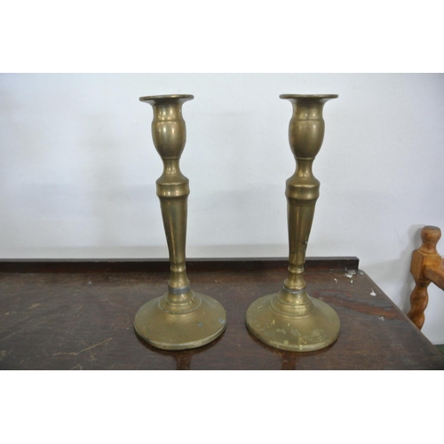 234 - An assortment of brass items to include a stunning three tier candelabra, three other candle sticks ... 