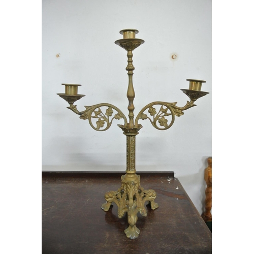 234 - An assortment of brass items to include a stunning three tier candelabra, three other candle sticks ... 