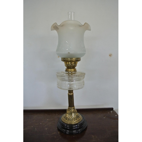 239 - A Victorian style oil lamp on decorative brass pillar, clear glass reservoir, and etched glass shade... 