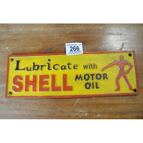 266 - A reproduction cast iron sign reading, 'Lubricate with motor oil - Shell'.