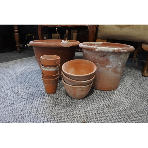 328 - An assortment of terracotta plant pots.