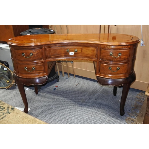 359 - An antique kidney shaped desk carved top.