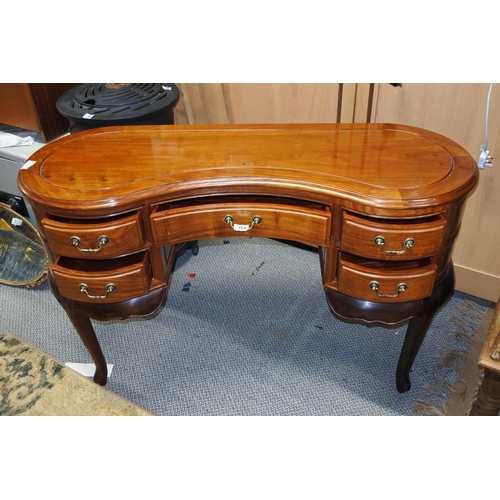 359 - An antique kidney shaped desk carved top.