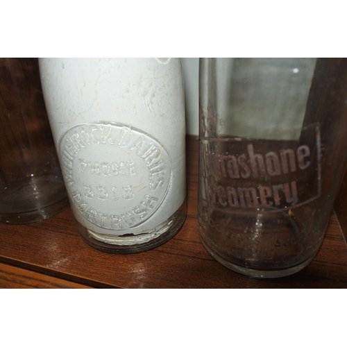 382 - A collection of three vintage milk bottles to include 'WHITEROCK DAIRIES PORTRUSH', 'ULSTER'S BEST M... 