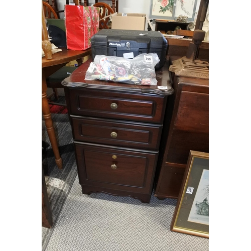 389 - A mahogany three drawer bedside locker.