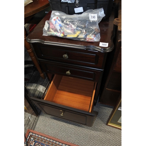 389 - A mahogany three drawer bedside locker.