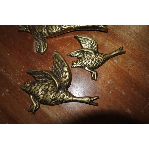 421 - A set of three mid-century style brass wall hanging geese.