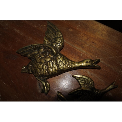 421 - A set of three mid-century style brass wall hanging geese.