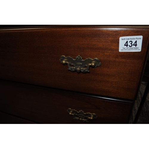 434 - A vintage chest of drawers with decorative metal fittings.