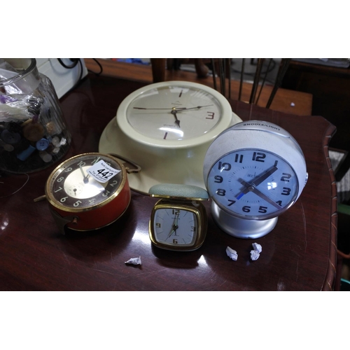 442 - An assortment of clocks to include two alarm clocks, a travel clock and a wall clock.