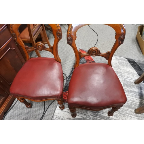 451 - A stunning pair of antique chairs with decorative splats and red leather upholster.