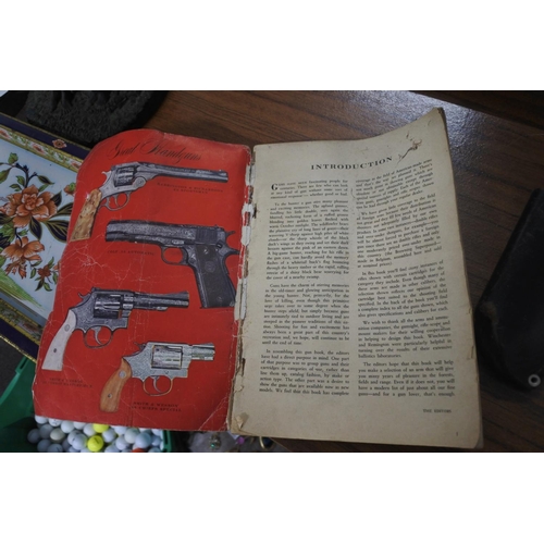 67 - A vintage leather gun holster along with retro GUNS booklet.