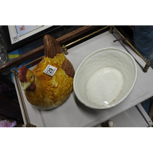 129 - A ceramic egg holder in the shape of a hen.