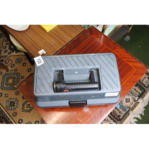 133 - A tackle box and contents to include a two Shakespeare reels, a Sunshine reel, and more.