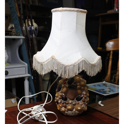 143 - A Dimple's whisky bottle which has been covered in shells and converted into a table lamp.