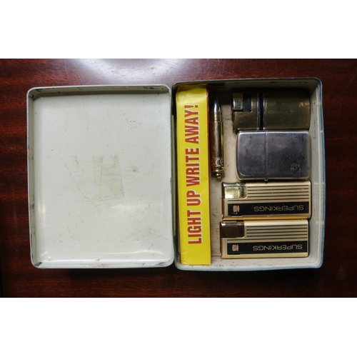 157 - Two vintage advertising tins along with an assortment of lighters.