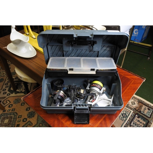 133 - A tackle box and contents to include a two Shakespeare reels, a Sunshine reel, and more.