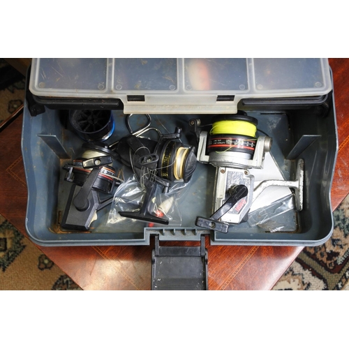 133 - A tackle box and contents to include a two Shakespeare reels, a Sunshine reel, and more.