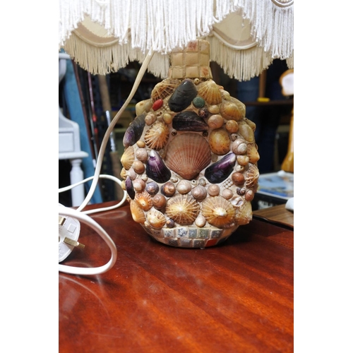 143 - A Dimple's whisky bottle which has been covered in shells and converted into a table lamp.