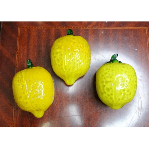 147 - Three vintage glass lemons on a silver plated tray.
