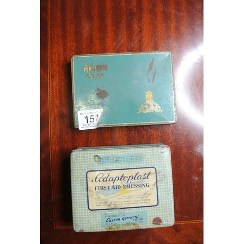 157 - Two vintage advertising tins along with an assortment of lighters.