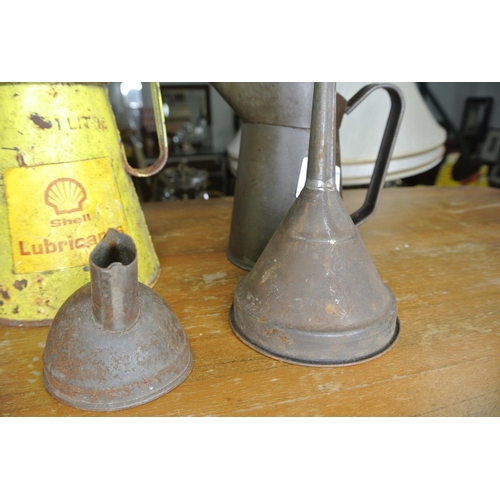 181 - A Shell Lubricants oil can, another oil can and two funnels.