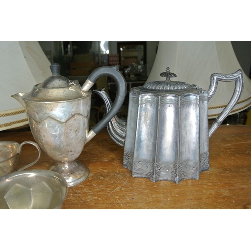 250 - An assortment of silver plate items to include two teapots, a coffee pot, sugar bowl and milk jug.