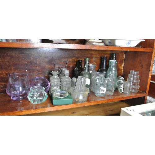 279 - A large assortment of glassware, to include antique bottles, cut glass items and more.