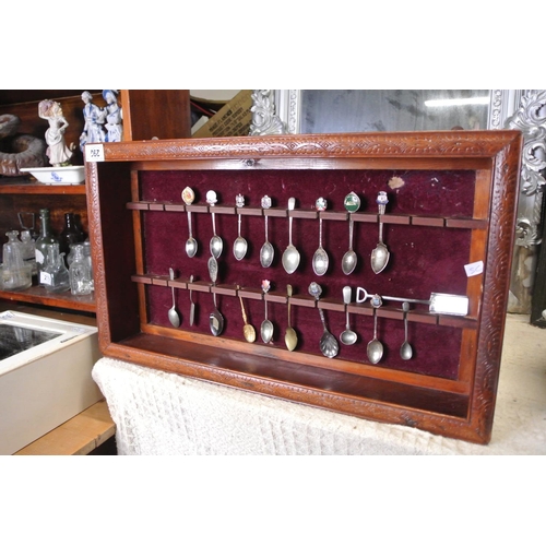 292 - A wooden spoon rack display with contents.