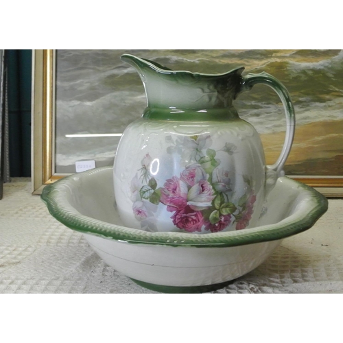 299 - A water jug and basin with decorative floral scenes.