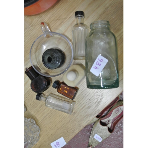 486 - An assortment of vintage glass bottles.