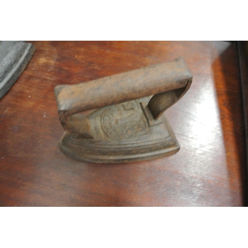 492 - A stone ware hot water bottle along with two cast iron irons.