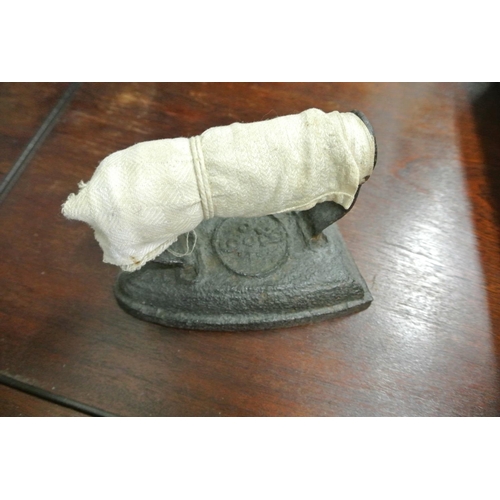 492 - A stone ware hot water bottle along with two cast iron irons.