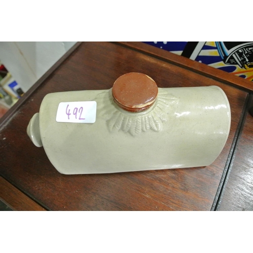 492 - A stone ware hot water bottle along with two cast iron irons.